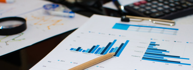 Desk with clipboard with graphs