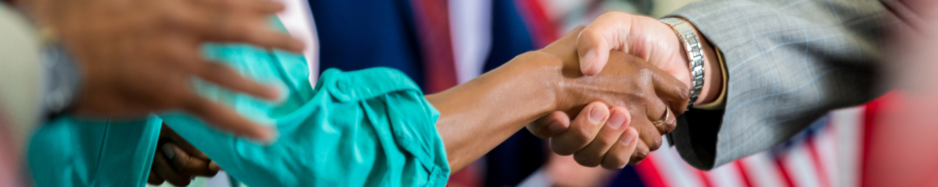 politician shaking hands with the public