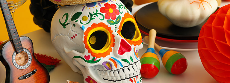 Sugar skull from La Dia de los Muertos, as well as a guitar and maracas