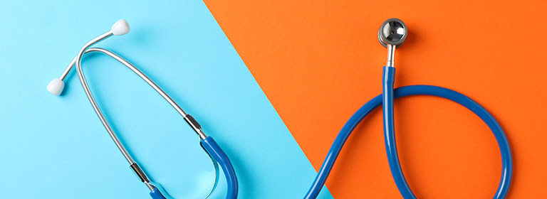 Stethoscope against a blue and orange background