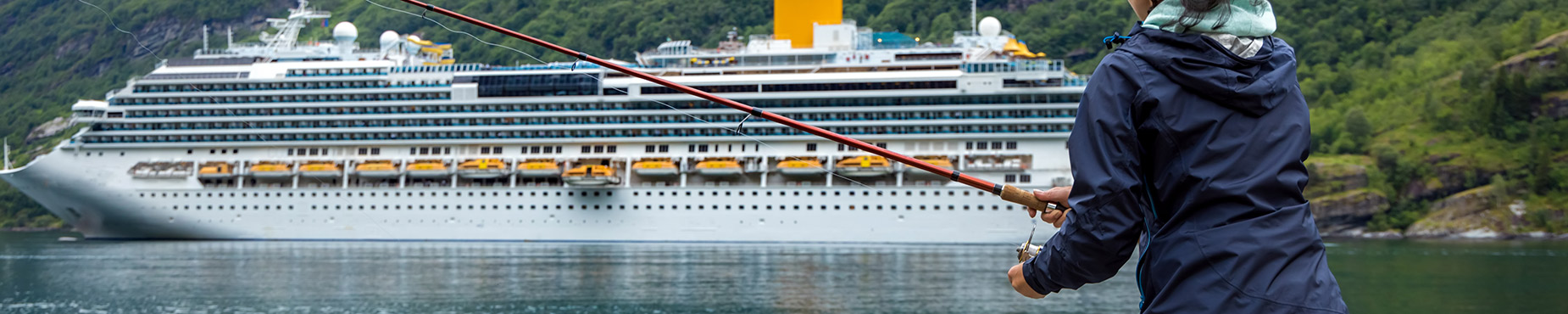 Woman fishing in front of a cruise ship