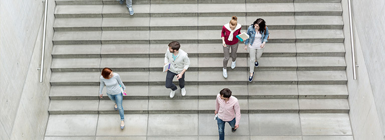 aerial shot of people walking down stairs